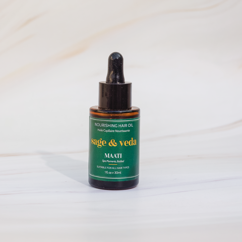 Sage & Veda Maati face Body oil 30ml bottle against neutral marble background.